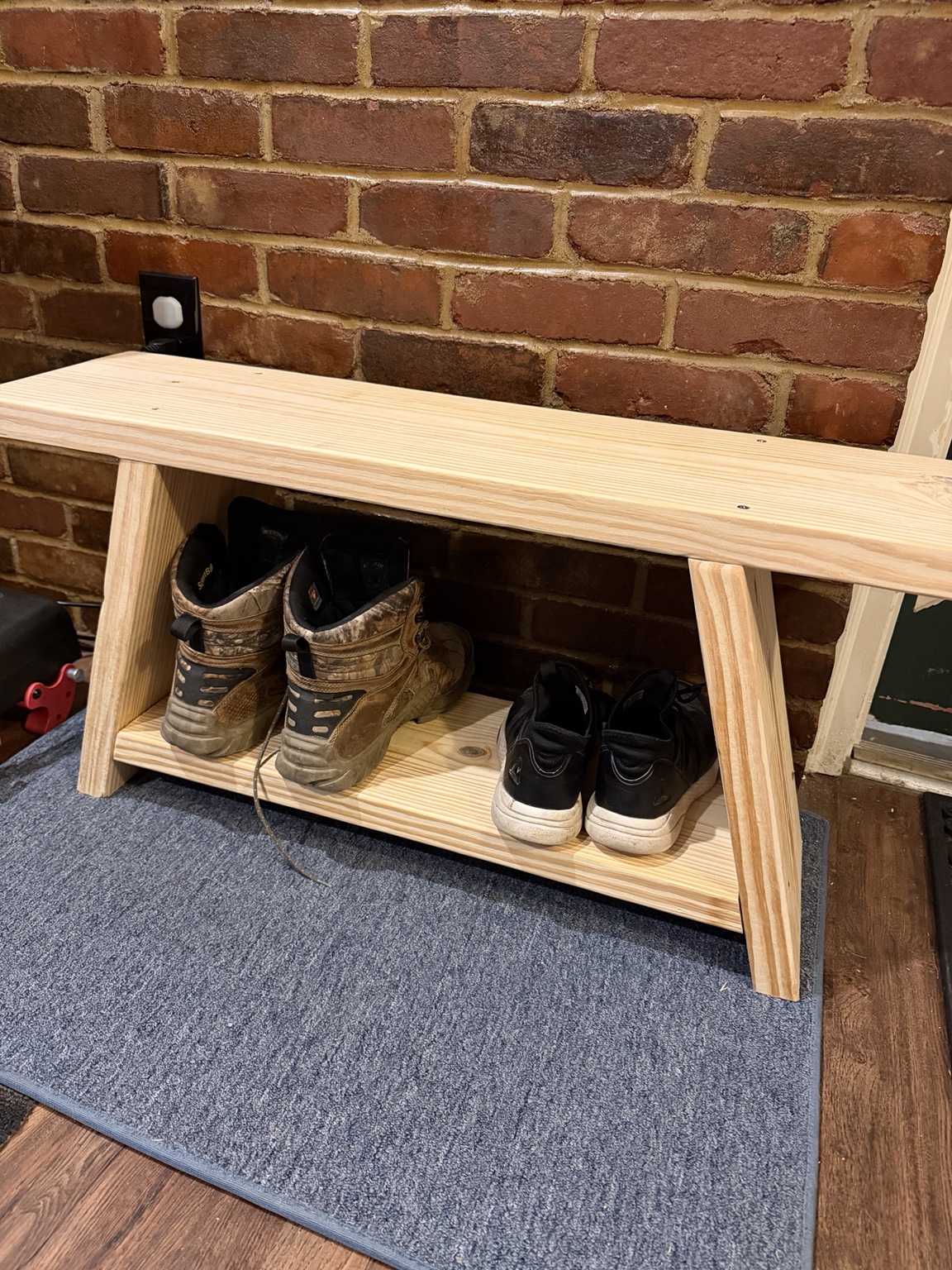 Natural wood entryway bench with a lower shoe shelf