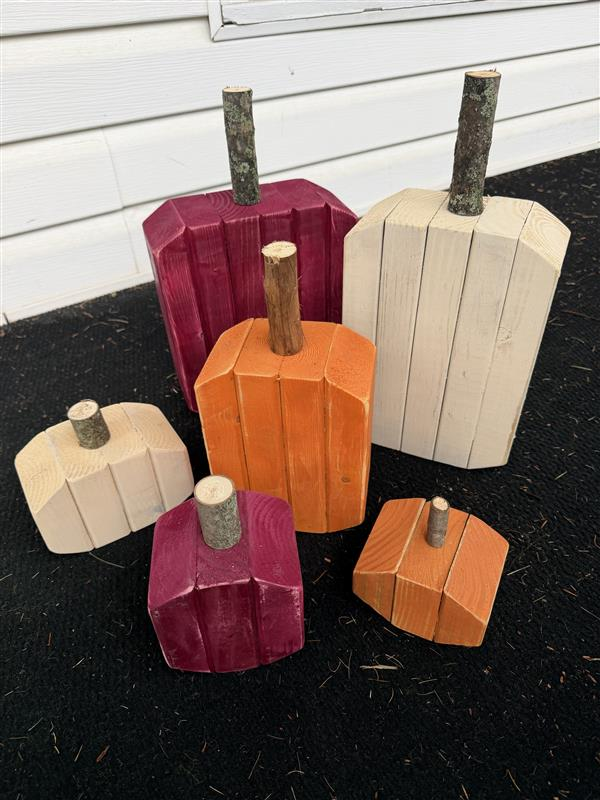 Collection of handcrafted wooden pumpkins in autumn colors